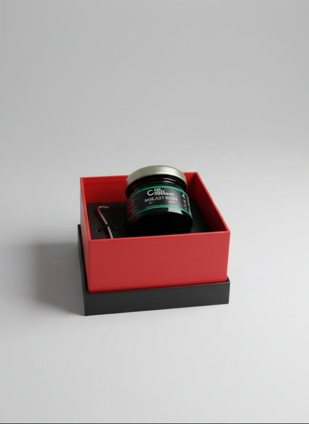 Organics Shilajit Resin in a red box on a wooden surface