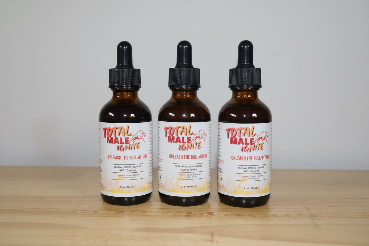 Three bottles of 'Total Male Ignite' on a wooden surface with a plain background